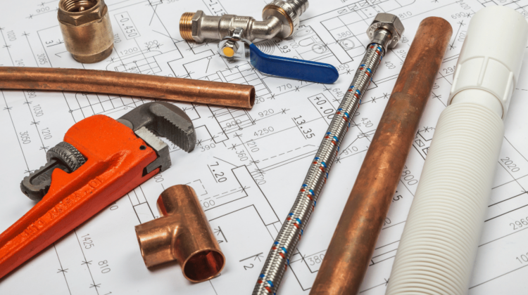 plumbing plans with pipe wrench and a variety of pipes and plumbing fixtures