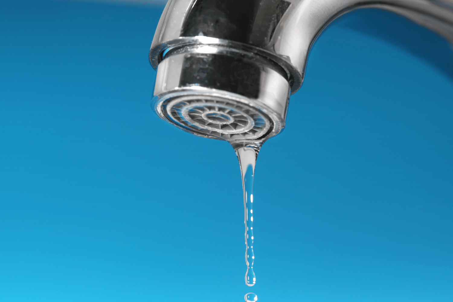 kitchen faucet dripping against blue background