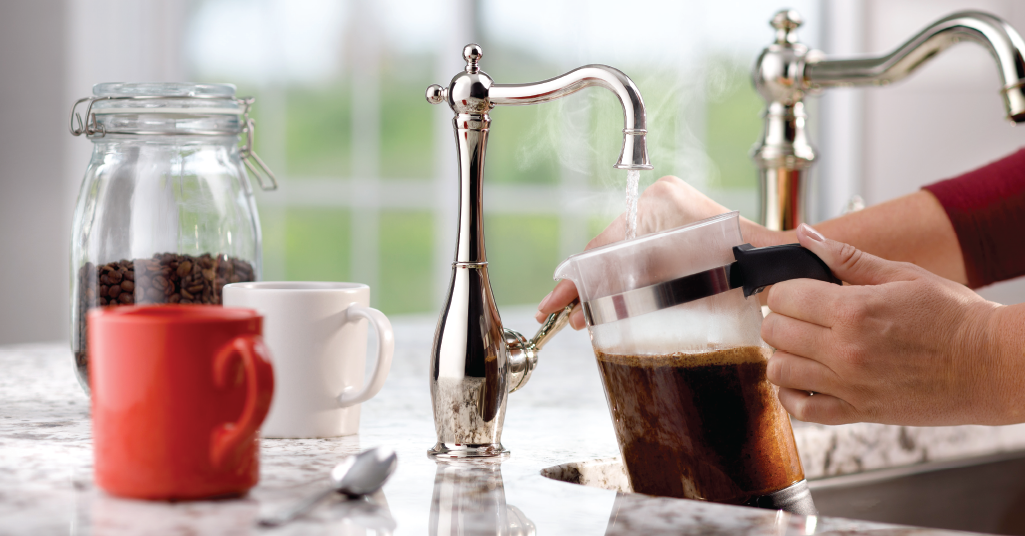 Woman filling coffee pot with water from instant water spigot