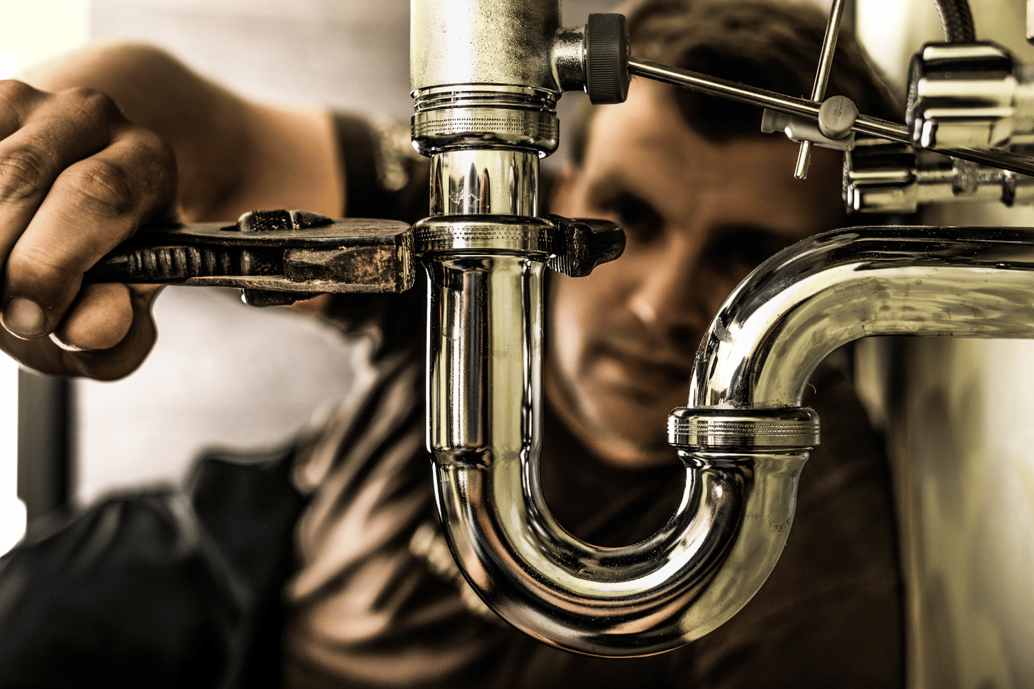 Plumber working on sink trap