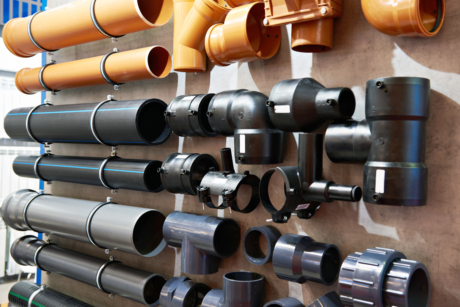 display of various types of pipes at hardware store